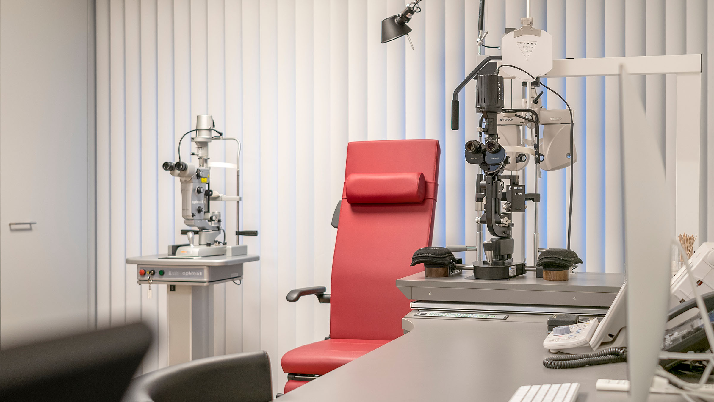 Empty red treatment chair in ophthalmologist's office